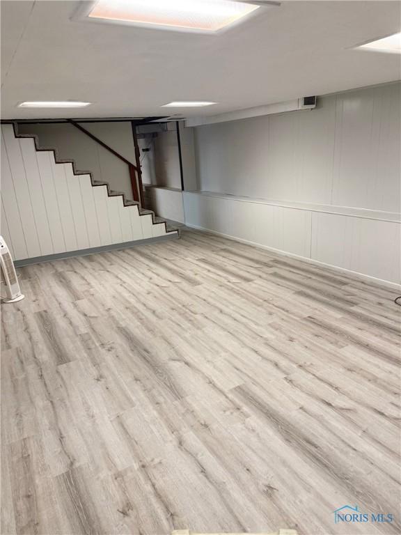 125 E Yates Ave, Findlay, OH 45840 - finished below grade area with wood finished floors, stairs, and a decorative wall