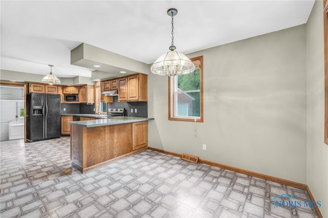21010 Lemoyne Rd, Luckey, OH 43443 - kitchen featuring black appliances, a chandelier, a peninsula, brown cabinets, and under cabinet range hood
