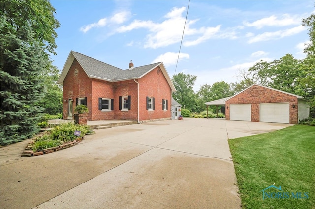 21010 Lemoyne Rd, Luckey, OH 43443 - view of home's exterior featuring brick siding, a garage, an outbuilding, a chimney, and a lawn