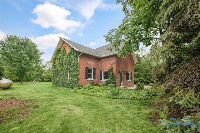 21010 Lemoyne Rd, Luckey, OH 43443 - view of home's exterior featuring brick siding and a lawn