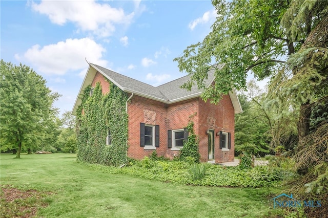 21010 Lemoyne Rd, Luckey, OH 43443 - view of side of property with brick siding, a lawn, and roof with shingles