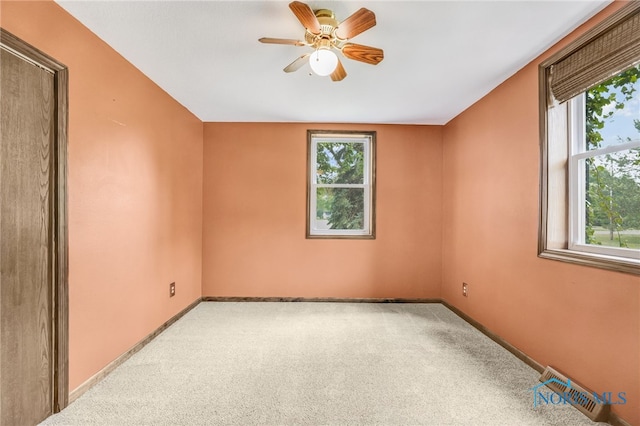 21010 Lemoyne Rd, Luckey, OH 43443 - carpeted empty room with healthy amount of natural light and ceiling fan