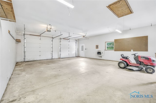 21010 Lemoyne Rd, Luckey, OH 43443 - garage featuring heating unit and a garage door opener