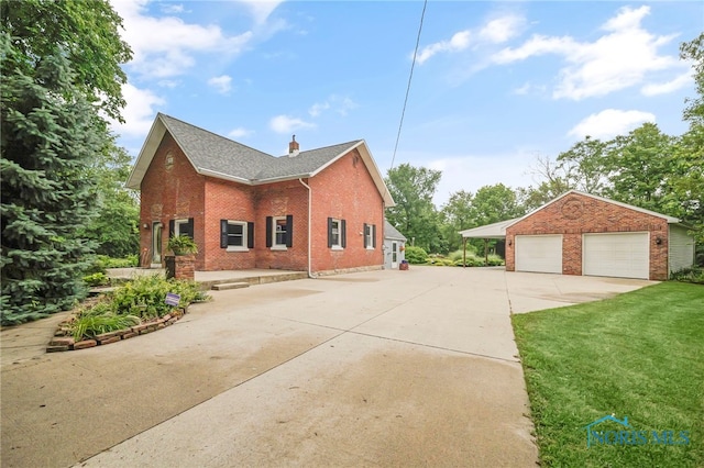 21010 Lemoyne Rd, Luckey, OH 43443 - view of home's exterior with brick siding, a detached garage, an outdoor structure, a chimney, and roof with shingles