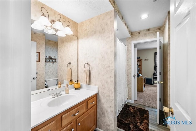 14 White Tail Way Unit A, Norwalk, OH 44857 - bathroom featuring vanity, wallpapered walls, and a chandelier