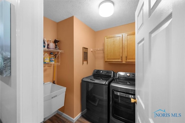 14 White Tail Way Unit A, Norwalk, OH 44857 - washroom with washer and dryer, cabinet space, wood finished floors, and a textured ceiling