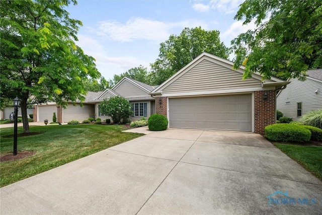 14 White Tail Way Unit A, Norwalk, OH 44857 - single story home with brick siding, a front lawn, concrete driveway, and an attached garage