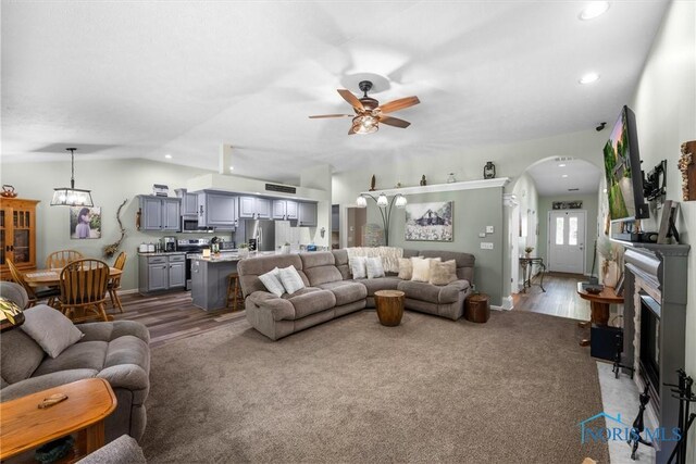 14 White Tail Way Unit A, Norwalk, OH 44857 - carpeted living area with arched walkways, ceiling fan, vaulted ceiling, recessed lighting, and a chandelier