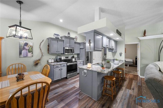 14 White Tail Way Unit A, Norwalk, OH 44857 - kitchen with stainless steel appliances, gray cabinets, a kitchen bar, a chandelier, and lofted ceiling