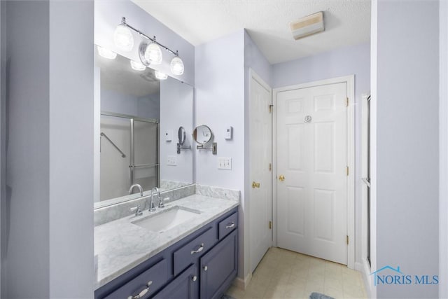 14 White Tail Way Unit A, Norwalk, OH 44857 - full bathroom with vanity, a shower stall, and a textured ceiling