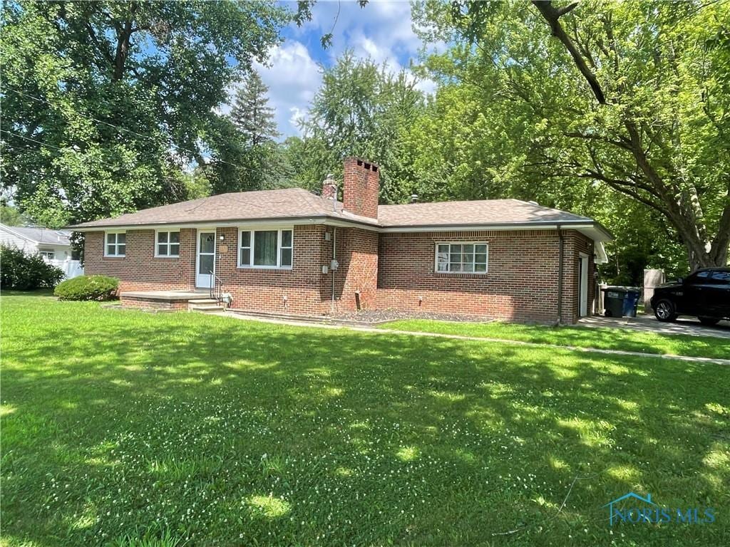 5626 Dorr St, Toledo, OH 43615 - single story home featuring brick siding, a front lawn, and a chimney