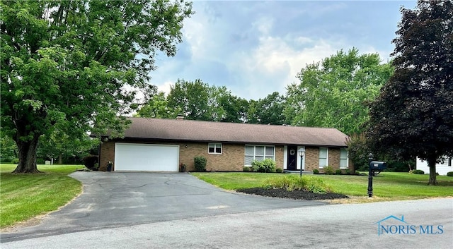 210 Duck Pond Rd, Upper Sandusky, OH 43351 - ranch-style house featuring an attached garage, a front lawn, asphalt driveway, and brick siding