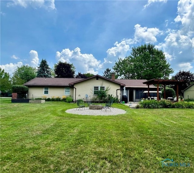 210 Duck Pond Rd, Upper Sandusky, OH 43351 - rear view of house featuring an outdoor fire pit, a yard, a patio, and a chimney