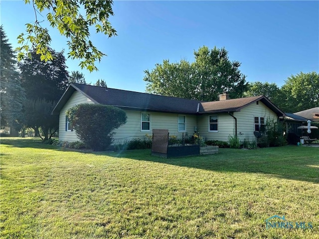 210 Duck Pond Rd, Upper Sandusky, OH 43351 - rear view of house featuring a lawn and a chimney