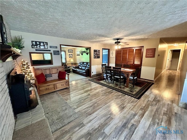 210 Duck Pond Rd, Upper Sandusky, OH 43351 - dining space with a textured ceiling, ceiling fan, and wood finished floors