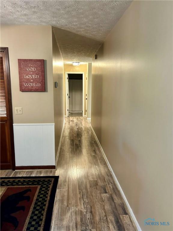 210 Duck Pond Rd, Upper Sandusky, OH 43351 - corridor featuring a textured ceiling and wood finished floors