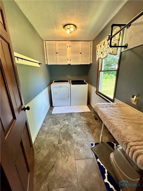 210 Duck Pond Rd, Upper Sandusky, OH 43351 - laundry area featuring independent washer and dryer, a textured ceiling, and cabinet space