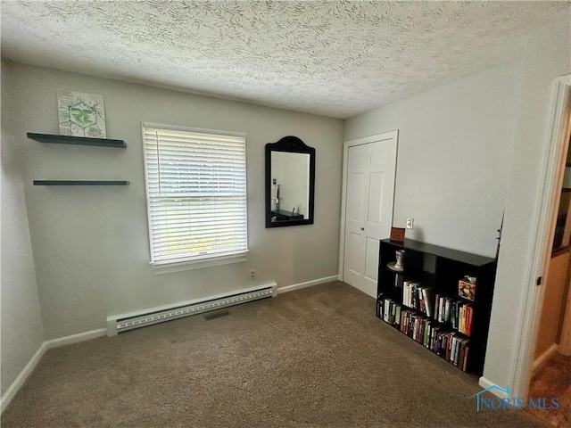 210 Duck Pond Rd, Upper Sandusky, OH 43351 - carpeted bedroom with baseboard heating, a closet, and a textured ceiling