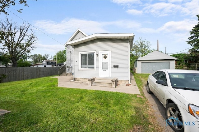 5520 N Summit St, Toledo, OH 43611 - shotgun-style home featuring a garage and an outbuilding