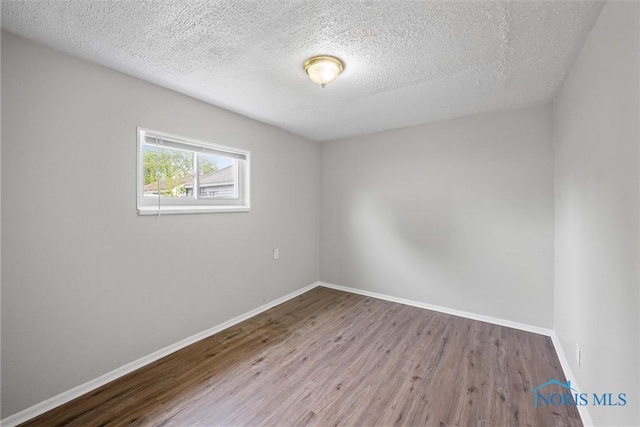 5520 N Summit St, Toledo, OH 43611 - spare room featuring wood finished floors and a textured ceiling