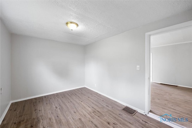 5520 N Summit St, Toledo, OH 43611 - spare room featuring a textured ceiling and wood finished floors