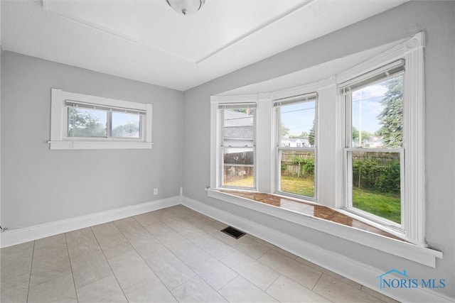 5520 N Summit St, Toledo, OH 43611 - empty room with plenty of natural light and tile patterned floors