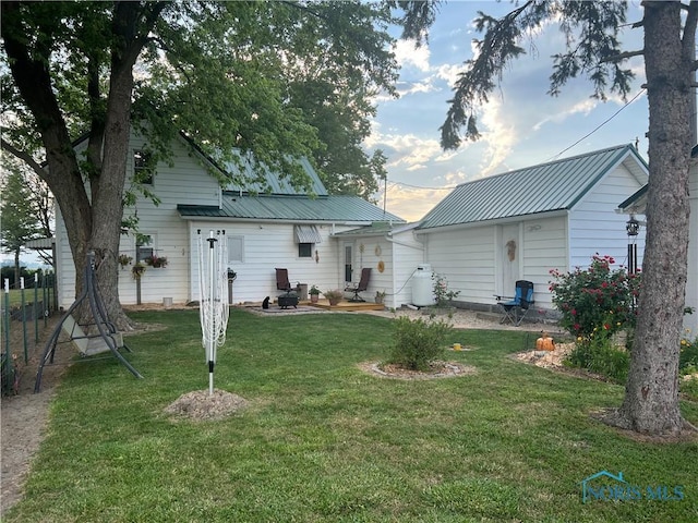 8872 Rd 87, Paulding, OH 45879 - rear view of property featuring a yard and a metal roof