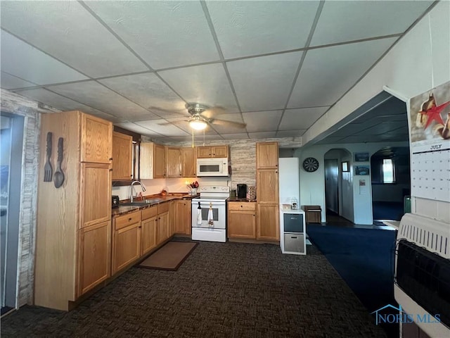 8872 Rd 87, Paulding, OH 45879 - kitchen with white appliances, heating unit, a drop ceiling, dark carpet, and ceiling fan
