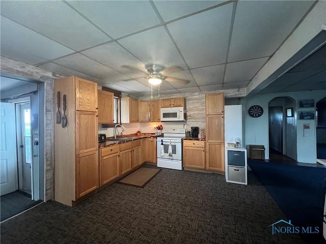 8872 Rd 87, Paulding, OH 45879 - kitchen with white appliances, dark colored carpet, a drop ceiling, a ceiling fan, and arched walkways