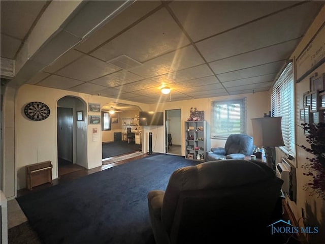 8872 Rd 87, Paulding, OH 45879 - carpeted living room with a drop ceiling, a ceiling fan, and arched walkways