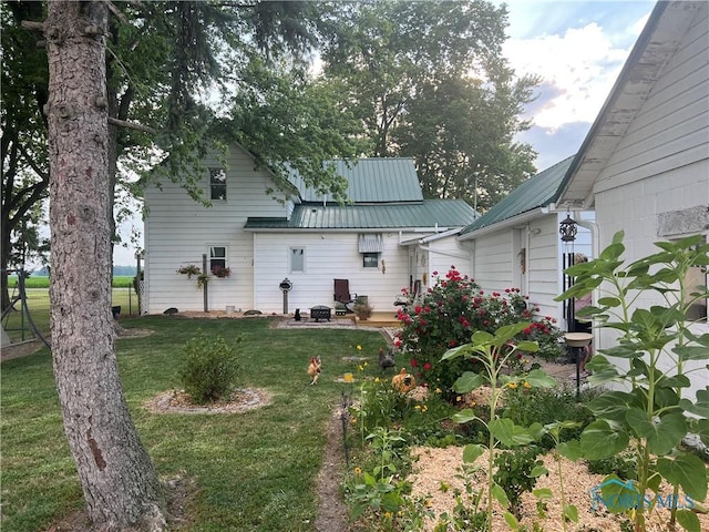 8872 Rd 87, Paulding, OH 45879 - rear view of house featuring a lawn, a metal roof, and a patio area