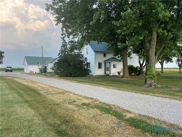8872 Rd 87, Paulding, OH 45879 - view of front of property with driveway, a metal roof, and a front lawn