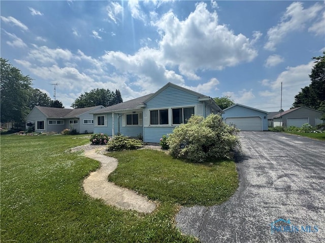1926 Tiffin Rd, Fremont, OH 43420 - ranch-style home featuring a front yard, a detached garage, and an outbuilding