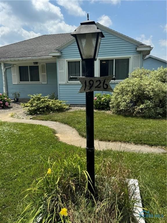 1926 Tiffin Rd, Fremont, OH 43420 - view of side of property with a yard and roof with shingles