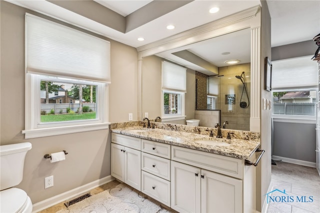 618 Sutton Pl, Findlay, OH 45840 - bathroom featuring tiled shower, double vanity, healthy amount of natural light, and recessed lighting