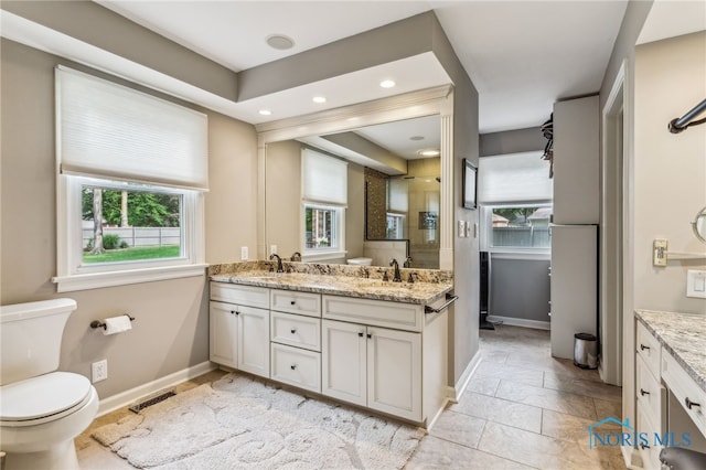 618 Sutton Pl, Findlay, OH 45840 - full bathroom with double vanity, an enclosed shower, recessed lighting, and stone tile floors
