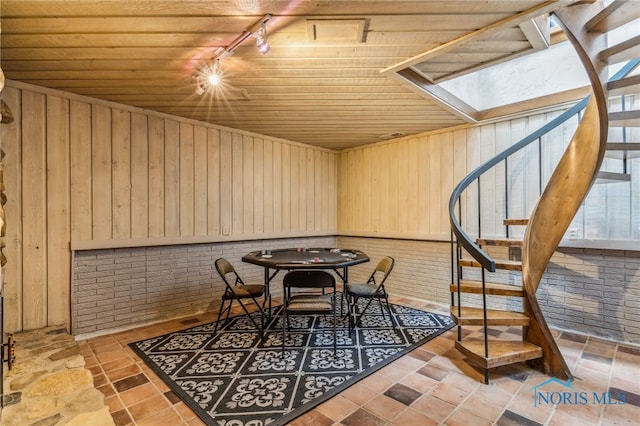 618 Sutton Pl, Findlay, OH 45840 - dining space with stairway, wood ceiling, track lighting, wooden walls, and a skylight