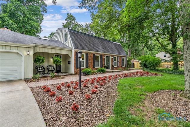 618 Sutton Pl, Findlay, OH 45840 - dutch colonial with a gambrel roof, roof with shingles, a garage, brick siding, and driveway