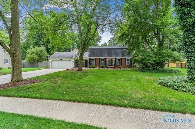 618 Sutton Pl, Findlay, OH 45840 - colonial inspired home with a garage, concrete driveway, a chimney, and brick siding