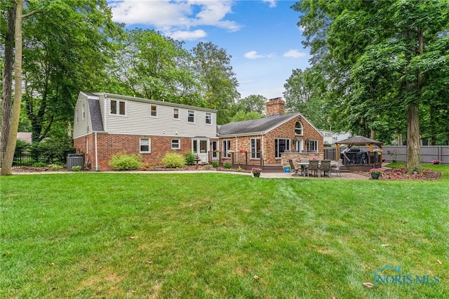618 Sutton Pl, Findlay, OH 45840 - rear view of house featuring a gazebo, brick siding, a patio area, and a chimney