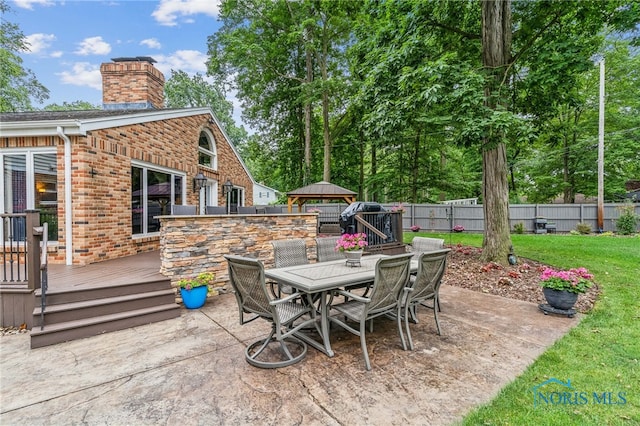 618 Sutton Pl, Findlay, OH 45840 - fenced backyard featuring a gazebo, a deck, a patio area, and outdoor dining space