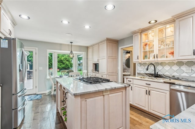 618 Sutton Pl, Findlay, OH 45840 - kitchen featuring appliances with stainless steel finishes, recessed lighting, backsplash, light wood-type flooring, and light stone counters