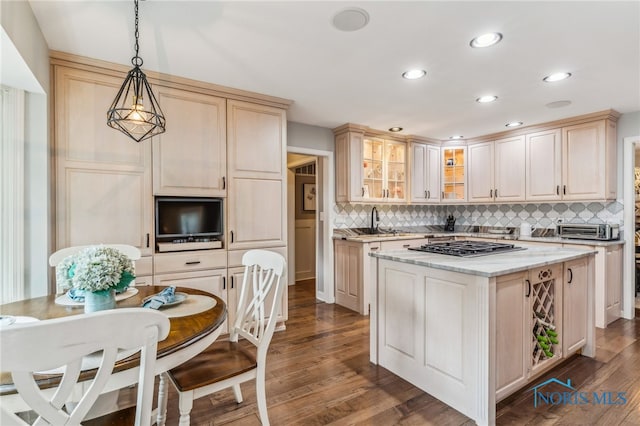 618 Sutton Pl, Findlay, OH 45840 - kitchen featuring tasteful backsplash, glass insert cabinets, dark wood-style flooring, a kitchen island, and decorative light fixtures