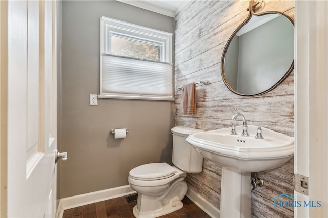 618 Sutton Pl, Findlay, OH 45840 - half bath featuring wooden walls, wood finished floors, and crown molding