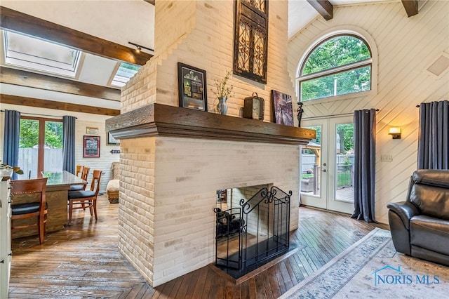618 Sutton Pl, Findlay, OH 45840 - living area featuring a brick fireplace, beam ceiling, a skylight, hardwood / wood-style floors, and high vaulted ceiling