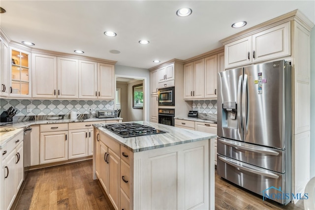618 Sutton Pl, Findlay, OH 45840 - kitchen with stainless steel appliances, tasteful backsplash, recessed lighting, wood finished floors, and light stone counters