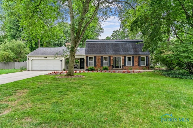 618 Sutton Pl, Findlay, OH 45840 - dutch colonial featuring an attached garage, concrete driveway, a shingled roof, and brick siding
