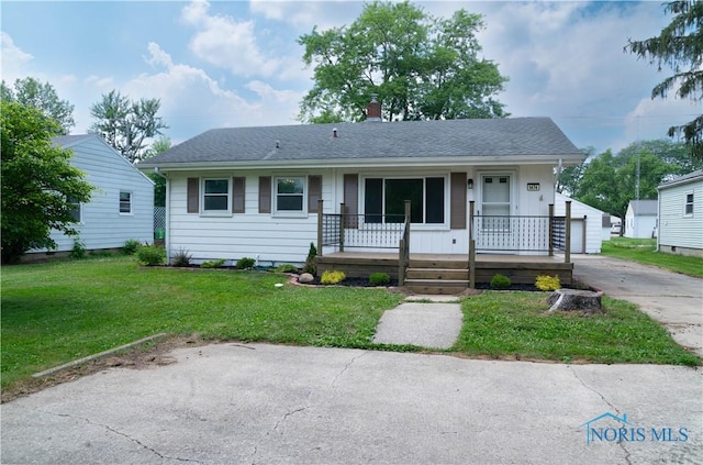 1474 S Clinton St, Defiance, OH 43512 - ranch-style home featuring a porch, a front yard, a chimney, a detached garage, and roof with shingles