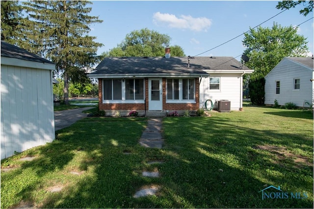 1474 S Clinton St, Defiance, OH 43512 - back of house with brick siding and a lawn