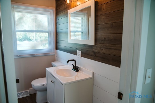 1474 S Clinton St, Defiance, OH 43512 - half bath with wood walls, vanity, and healthy amount of natural light